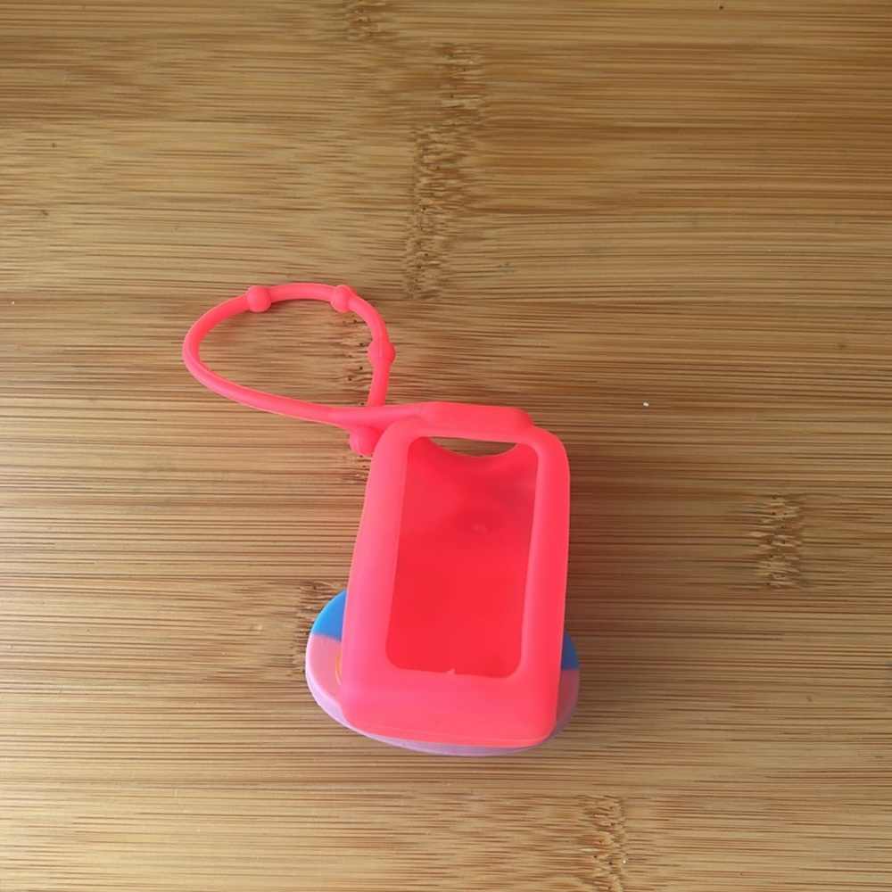 Colorful Smiling Poop Emoji hand sanitizer holder - Picture 3 of 4